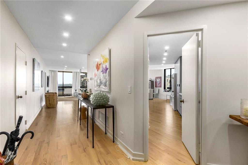 2660 Peachtree Road Northwest, Unit 18H Atlanta, GA 30305 - Photo 3 of 61 a view of a hallway with wooden floor windows and a livingroom