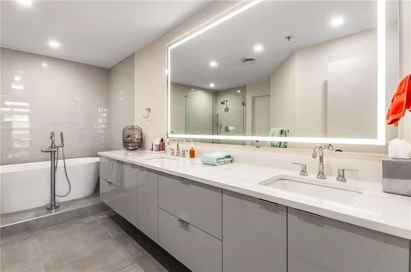 a bathroom with a double vanity sink and mirror