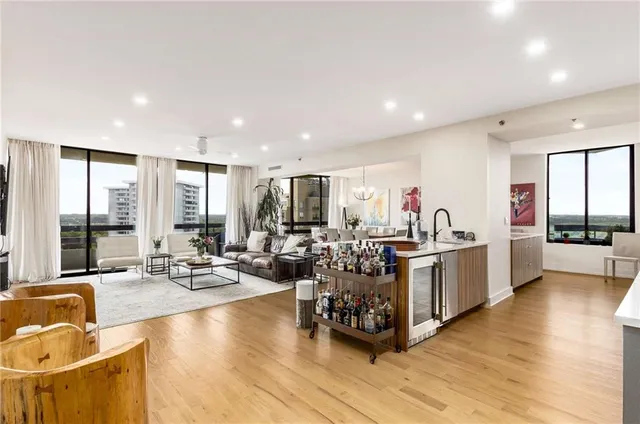 a very nice looking room with many windows and furniture