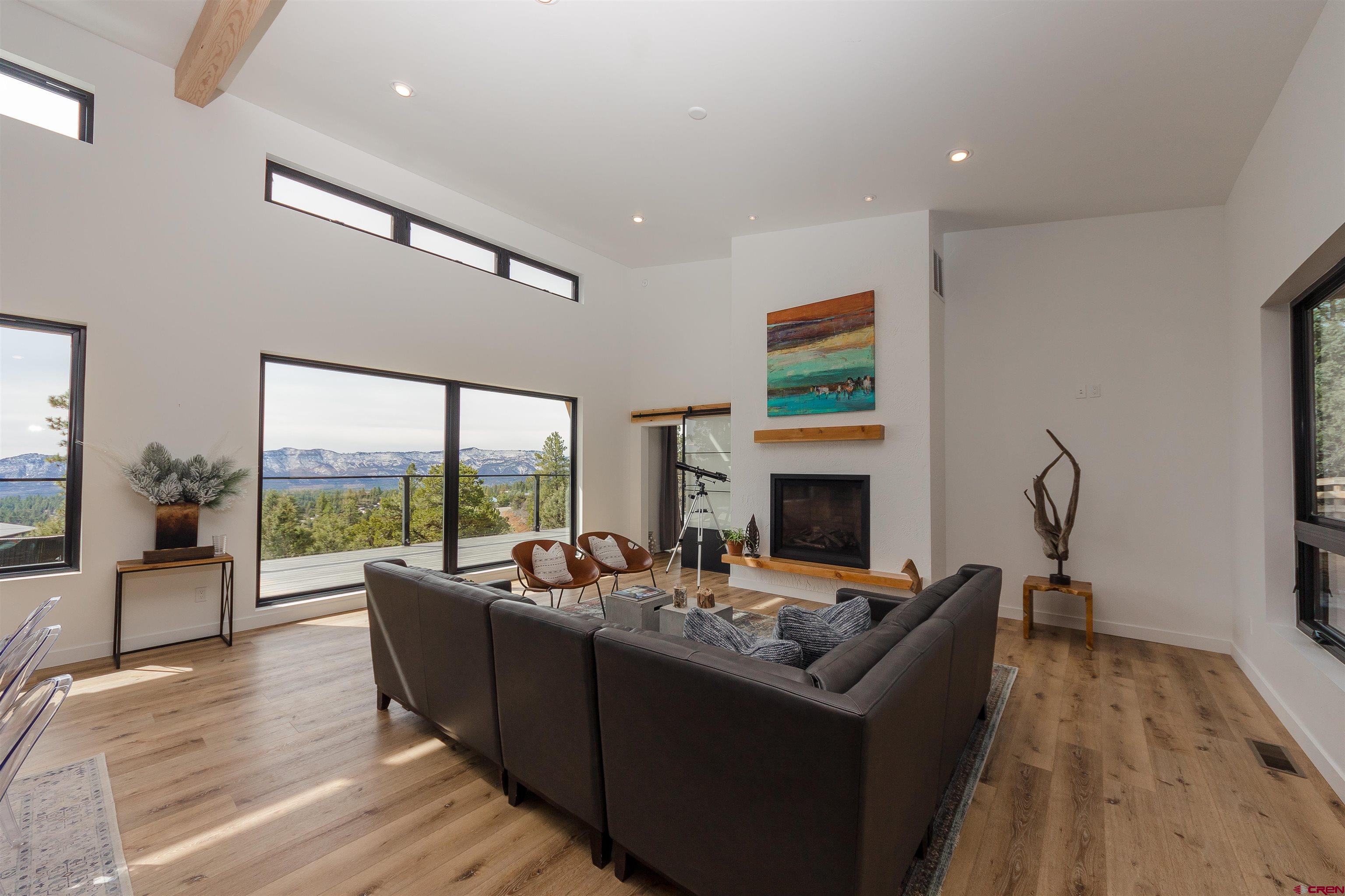 405 Far View Road Durango, CO 81303 - Photo 14 of 35 a living room with furniture large window and a fireplace