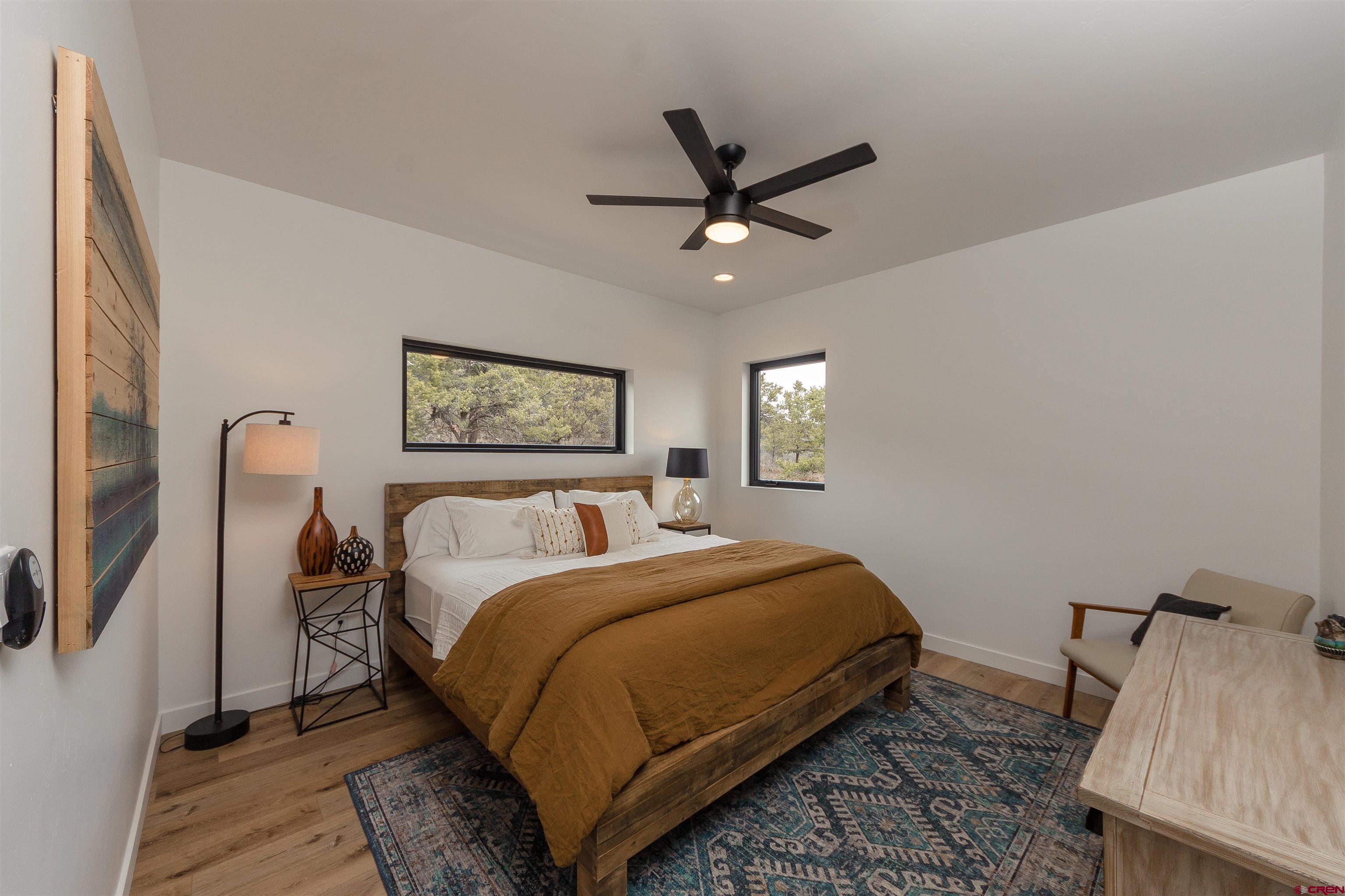 405 Far View Road Durango, CO 81303 - Photo 24 of 35 a bedroom with a bed a couch and a window