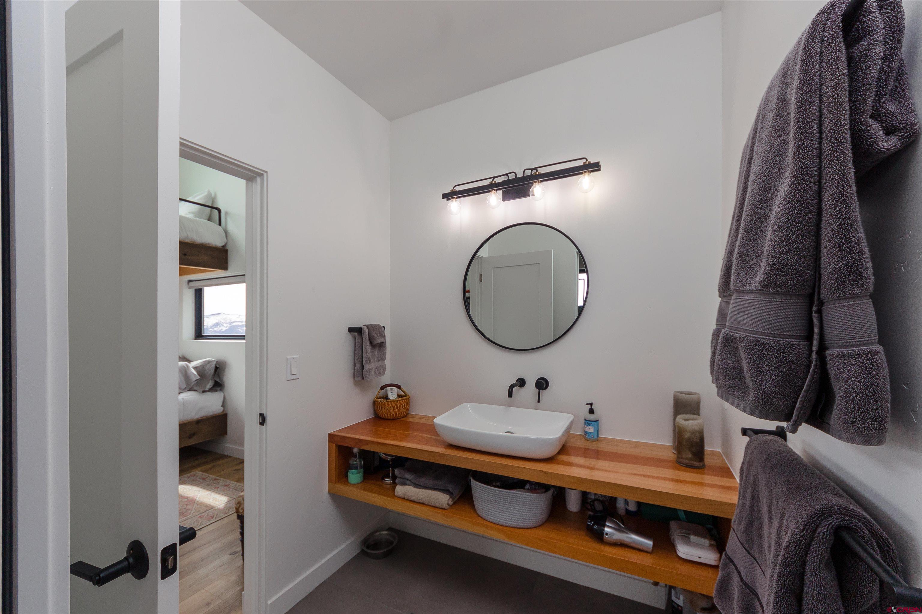 405 Far View Road Durango, CO 81303 - Photo 28 of 35 a bathroom with a sink and a mirror