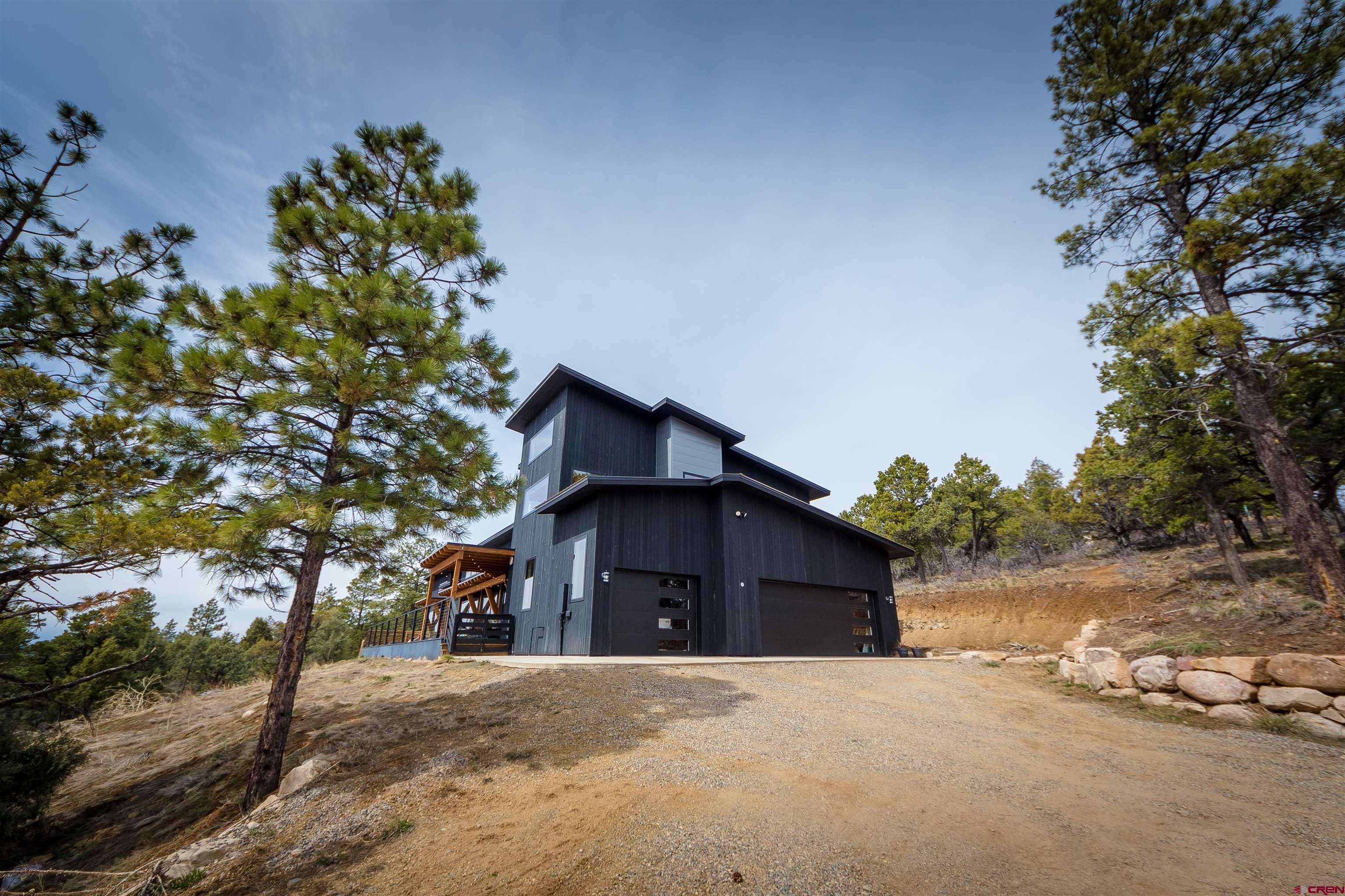 405 Far View Road Durango, CO 81303 - Photo 35 of 35 a front view of a house with a yard and garage