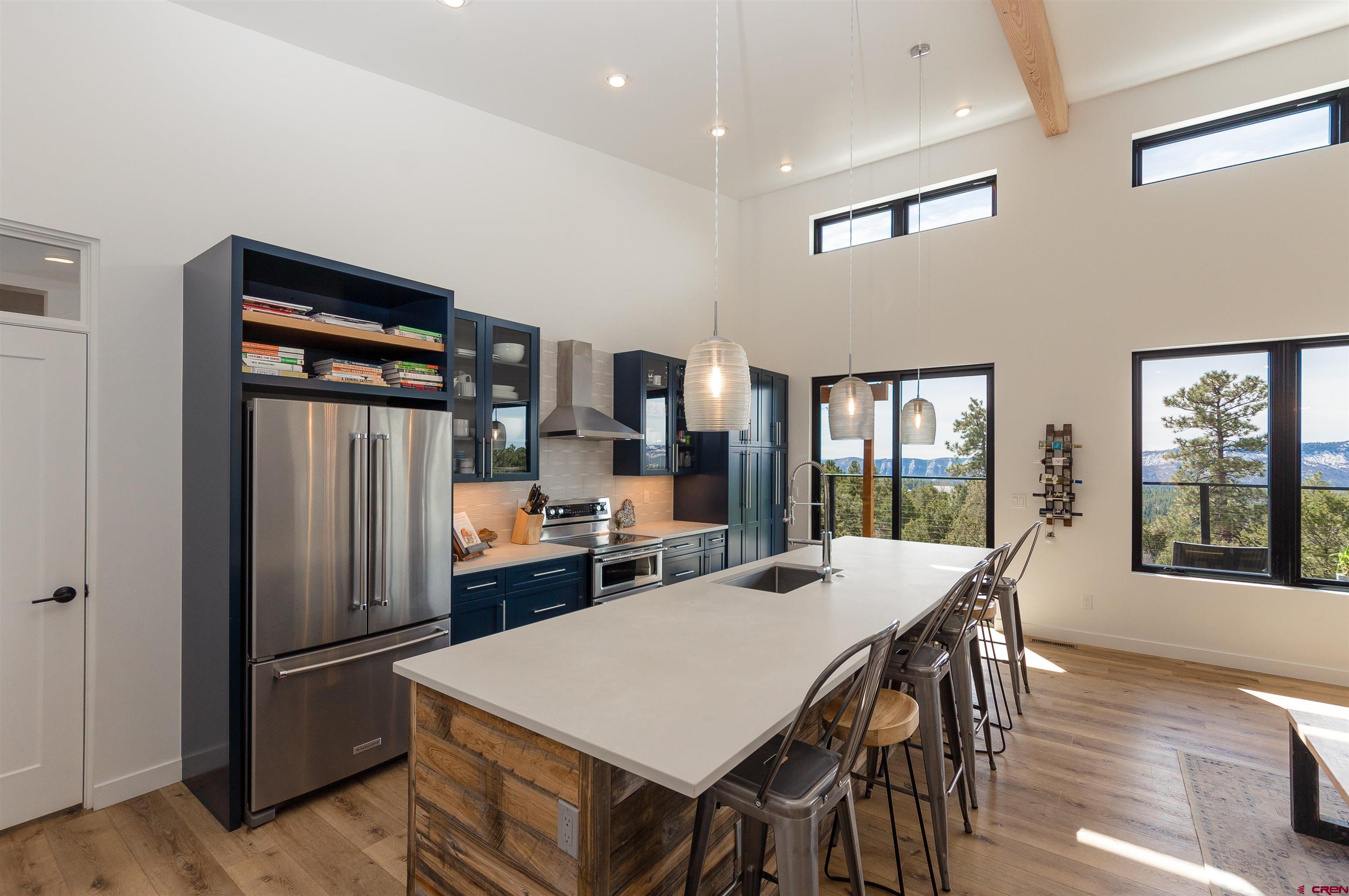 405 Far View Road Durango, CO 81303 - Photo 9 of 35 a kitchen with stainless steel appliances granite countertop a refrigerator a stove a sink a dining table and chairs