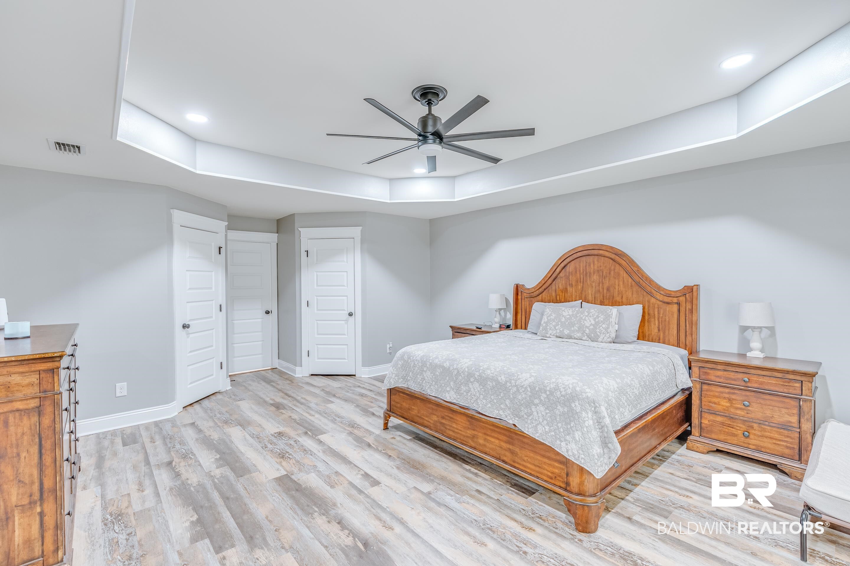 13235 Tom Gaston Road Mobile, AL 36695 - Photo 16 of 43 Bedroom with light hardwood / wood-style floors, a raised ceiling, and ceiling fan
