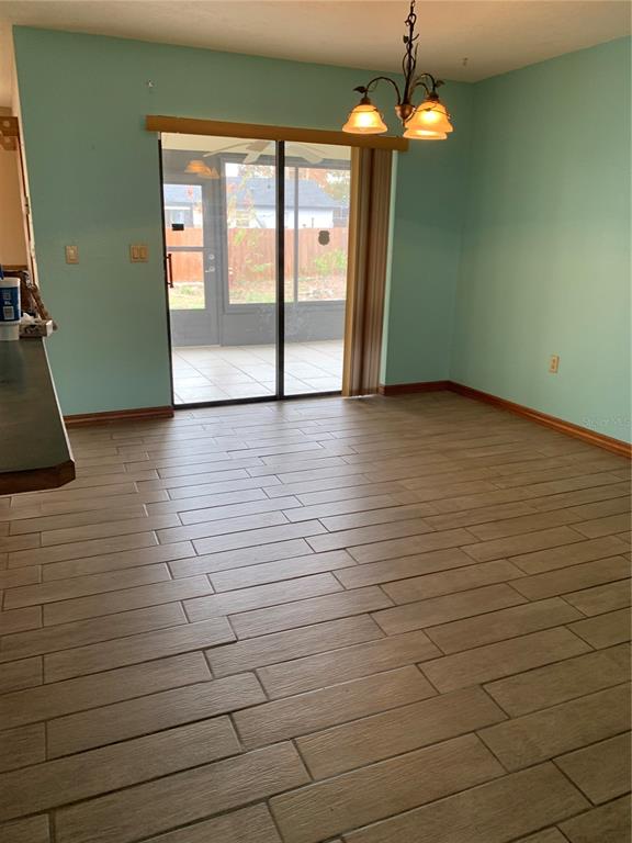 5140 Courtland Road Spring Hill, FL 34608 - Photo 6 of 20 a view of empty room with wooden floor and fan