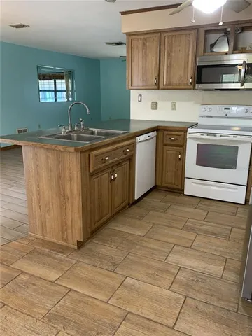 a kitchen with stainless steel appliances granite countertop a sink stove and cabinets
