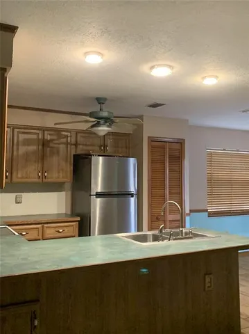 a kitchen with a sink and refrigerator