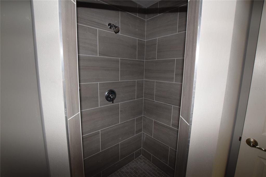 935 East McDonald Avenue Eustis, FL 32726 - Photo 11 of 12 a bathroom with a shower