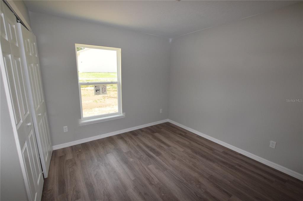 935 East McDonald Avenue Eustis, FL 32726 - Photo 12 of 12 a view of an empty room with wooden floor and a window