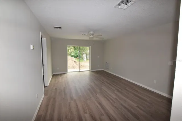 a view of a kitchen with a sink and wooden floor