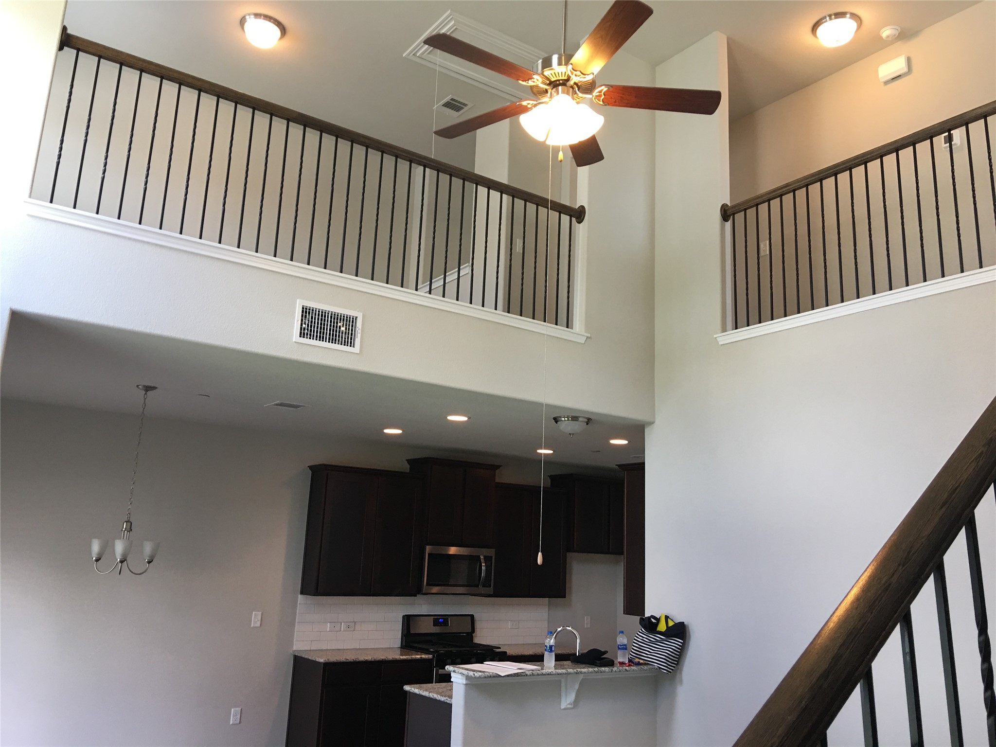 1612 Airedale Road Austin, TX 78748 - Photo 6 of 26 Kitchen featuring a ceiling fan, stainless steel appliances, light stone countertops, backsplash, and pendant lighting