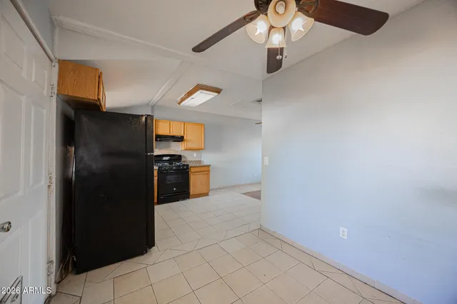 a kitchen with granite countertop a refrigerator and a stove