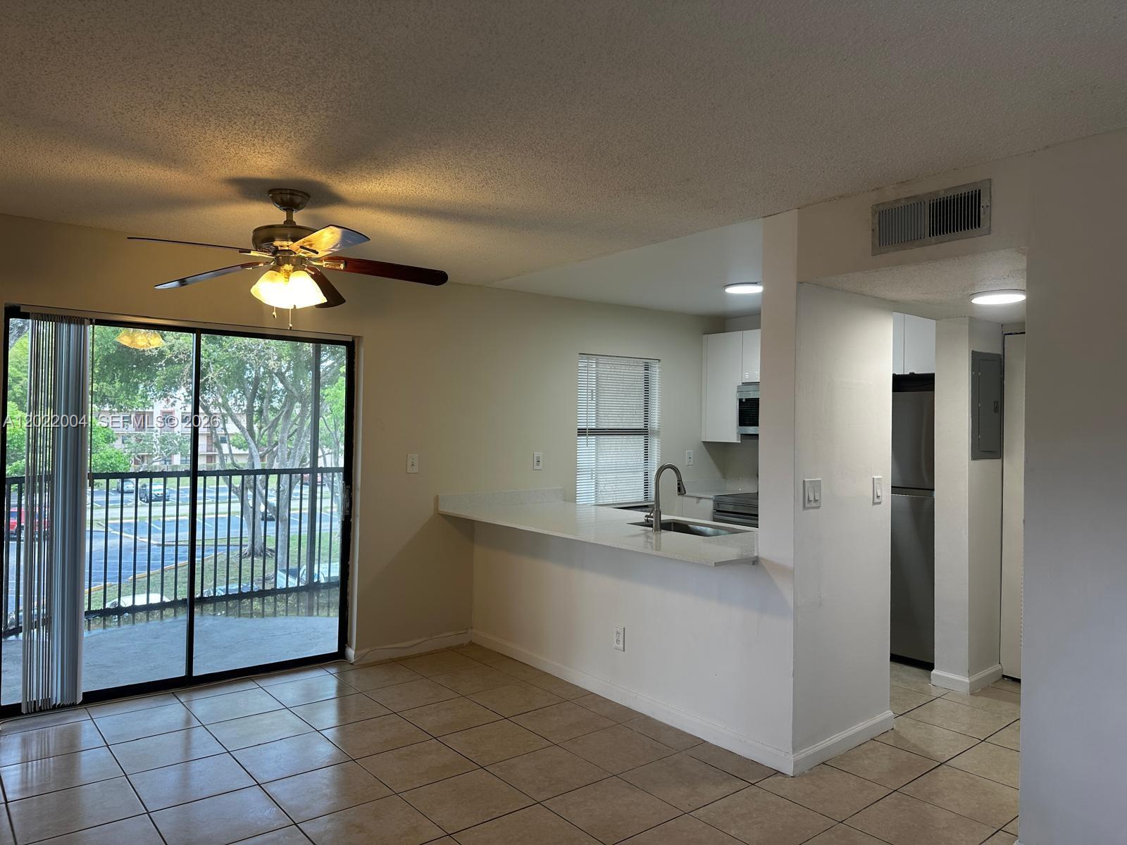 3400 Foxcroft Road, Unit 301 Miramar, FL 33025 - Photo 34 of 72 a kitchen with stainless steel appliances granite countertop a sink and a refrigerator