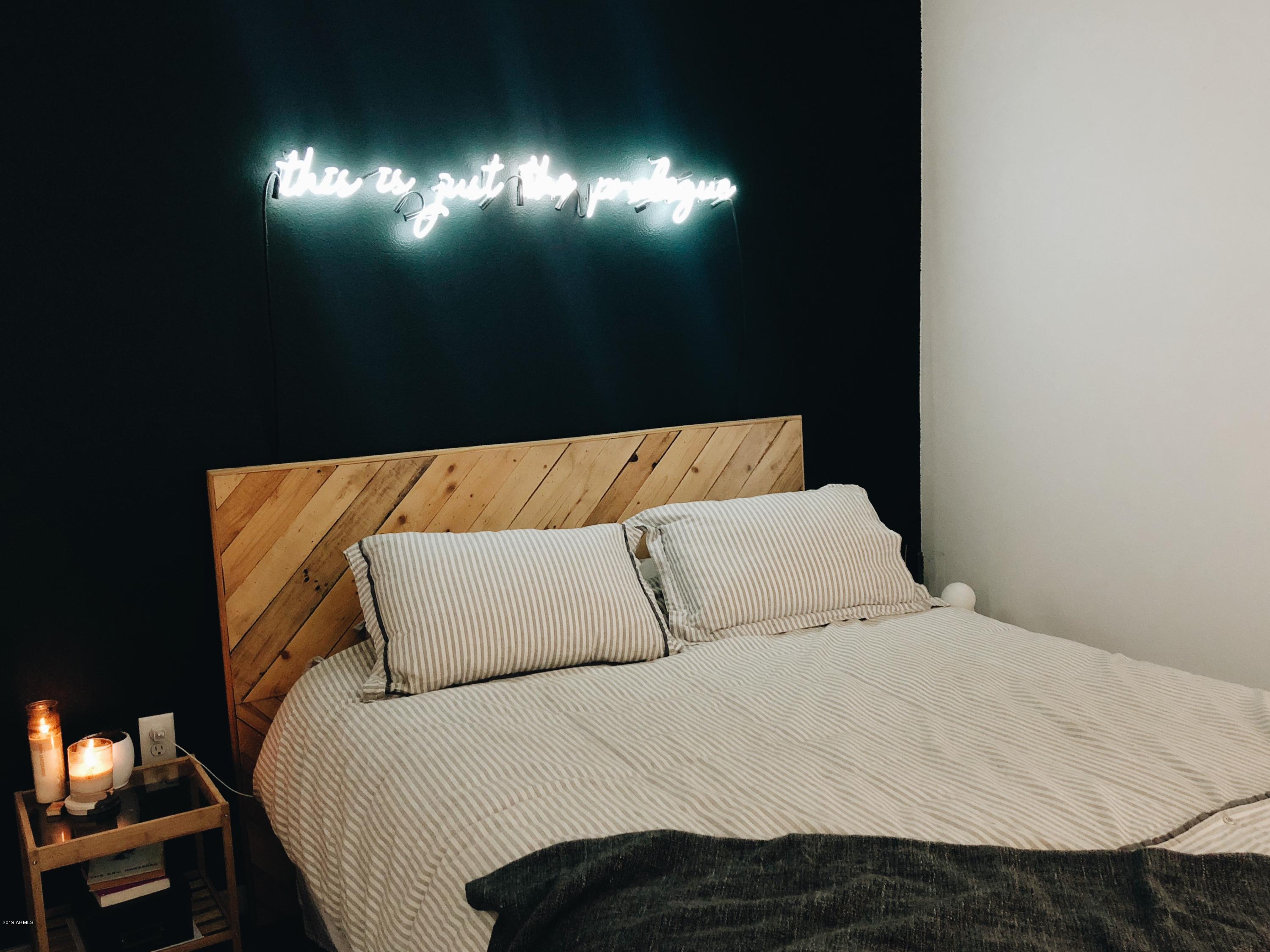 1130 North 2nd Street, Unit 306 Phoenix, AZ 85004 - Photo 4 of 19 a bed sitting in a bedroom next to a lamp