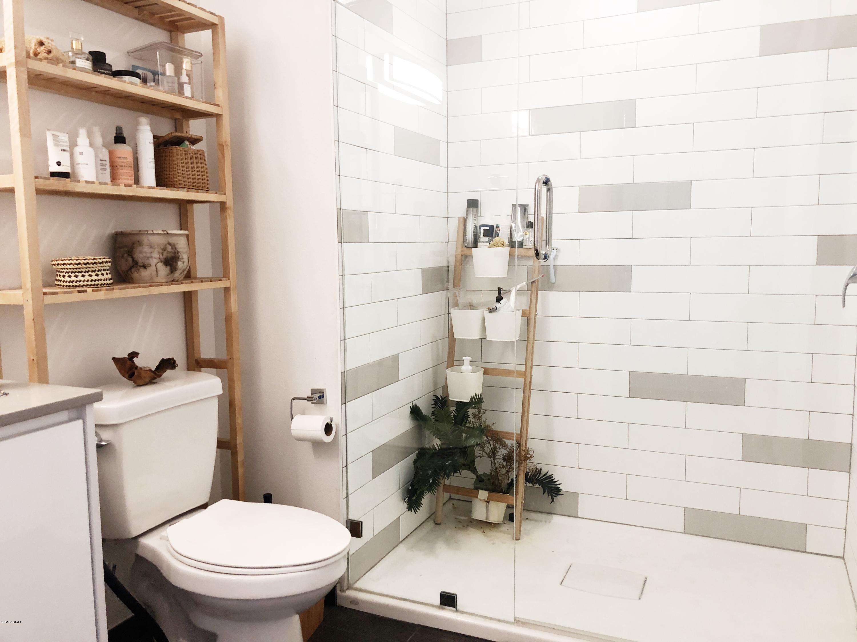 1130 North 2nd Street, Unit 306 Phoenix, AZ 85004 - Photo 7 of 19 a bathroom with a sink a toilet and shower