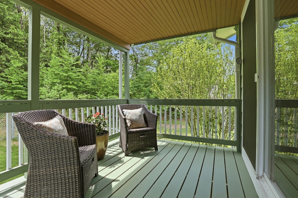 33 Simon Willard Road Acton, MA 01720 - Photo 30 of 42 a balcony with wooden floor outdoor seating and nature
