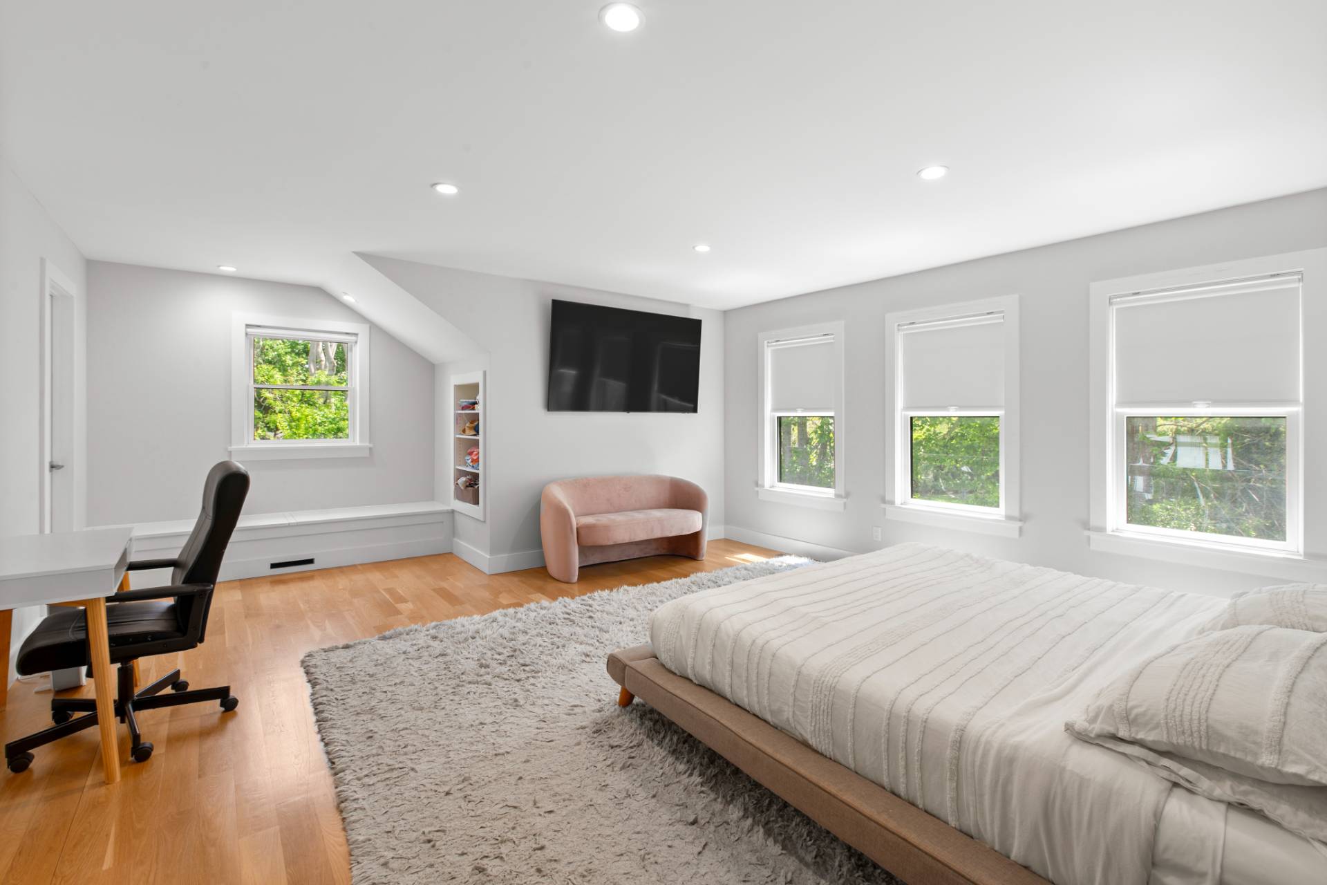 87 Accabonac Road East Hampton, NY 11937 - Photo 7 of 21 a bedroom with a bed a chair and a flat screen tv