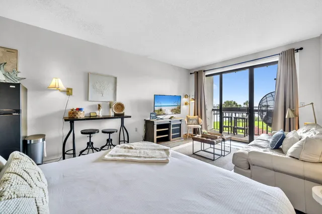 a living room with furniture fireplace and a large window