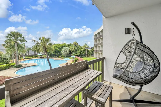 a view of a balcony with two chairs and a table