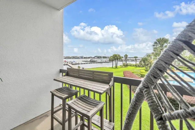 a view of a swimming pool with a porch and furniture