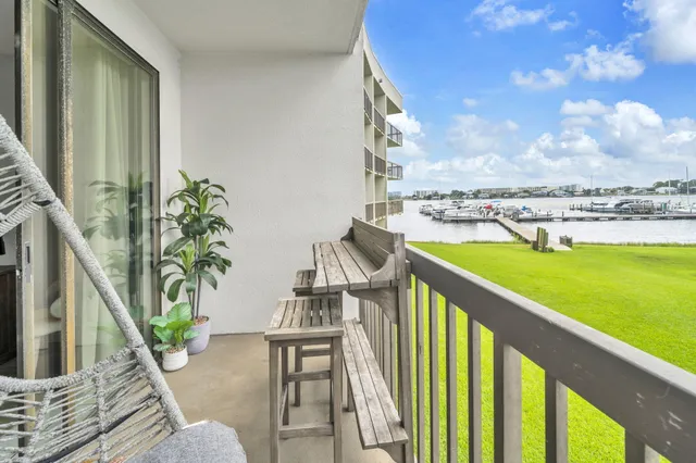 a view of building with cars parked in front of it