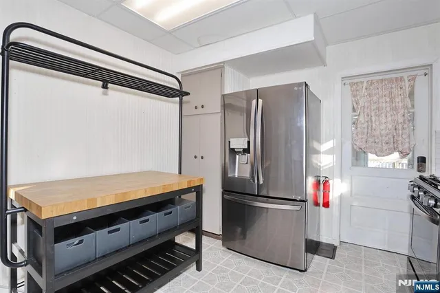 a kitchen with stainless steel appliances granite countertop a refrigerator and a stove