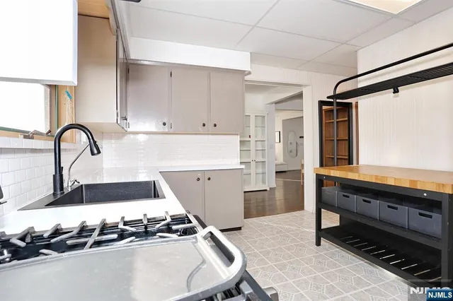 a kitchen with kitchen island granite countertop a stove and a sink
