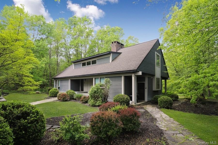 a view of a house with garden and yard