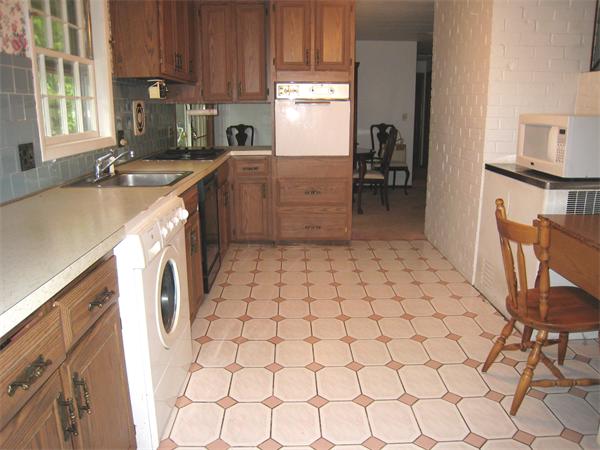 22 Temi Road Chelmsford, MA 01824 - Photo 5 of 8 a kitchen with a sink a stove and a refrigerator