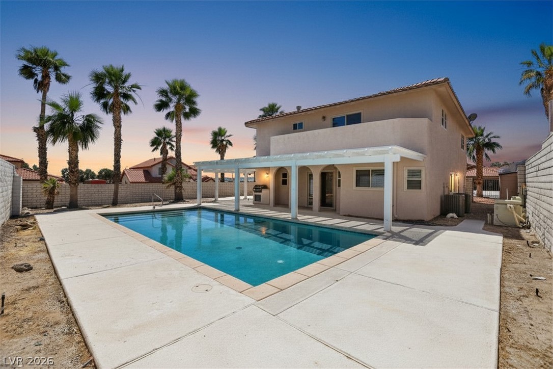 3698 Laughlin Boulevard Laughlin, NV 89029 - Photo 2 of 49 An inviting in-ground pool awaits under a covered patio for ultimate outdoor leisure.