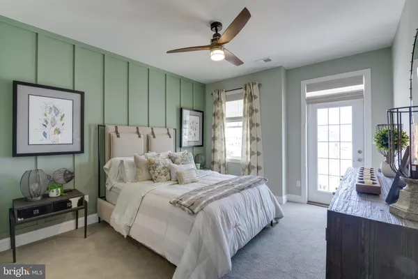 a bedroom with a bed a couch and a window