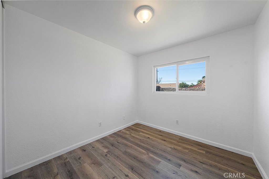 917 Renee Street Redlands, CA 92374 - Photo 20 of 26 One of three bedrooms newly painted, new flooring, lighting.