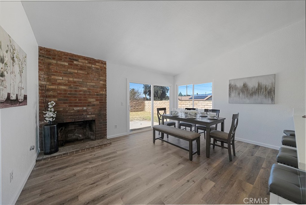 917 Renee Street Redlands, CA 92374 - Photo 10 of 26 Spacious area to dine off from the kitchen and room for more. Large peninsula counter can accommodate four comfortably. Brick fireplace adds character and charm to the room.