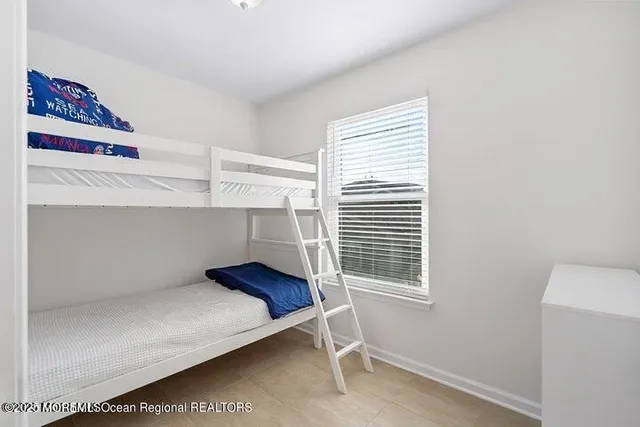 a bed sitting in a bedroom next to a window