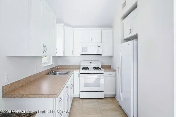 a kitchen with a sink stove and refrigerator