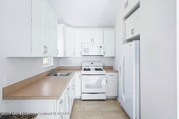 109 West Pompano Way Lavallette, NJ 08735 - Photo 9 of 18 a kitchen with a sink stove and refrigerator