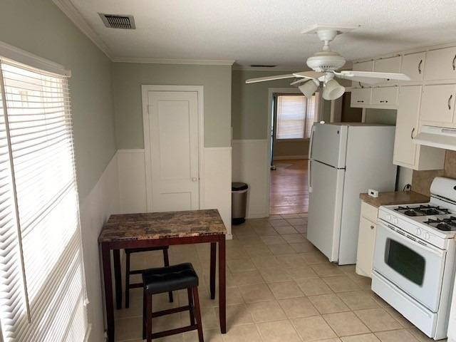 2611 31st Street Lubbock, TX 79410 - Photo 5 of 15 a kitchen with a refrigerator and a stove top oven