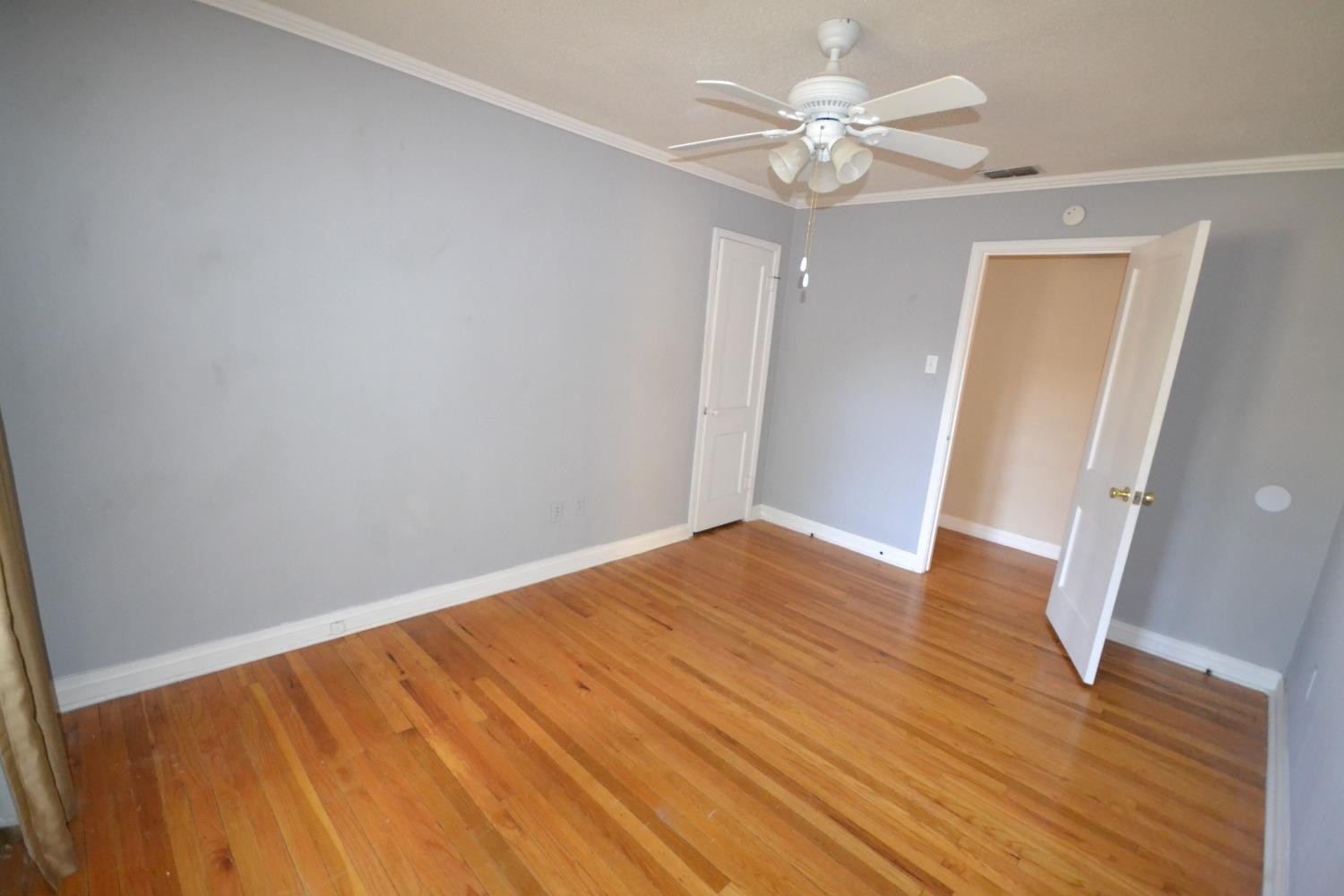 2611 31st Street Lubbock, TX 79410 - Photo 9 of 15 wooden floor in an empty room with a window