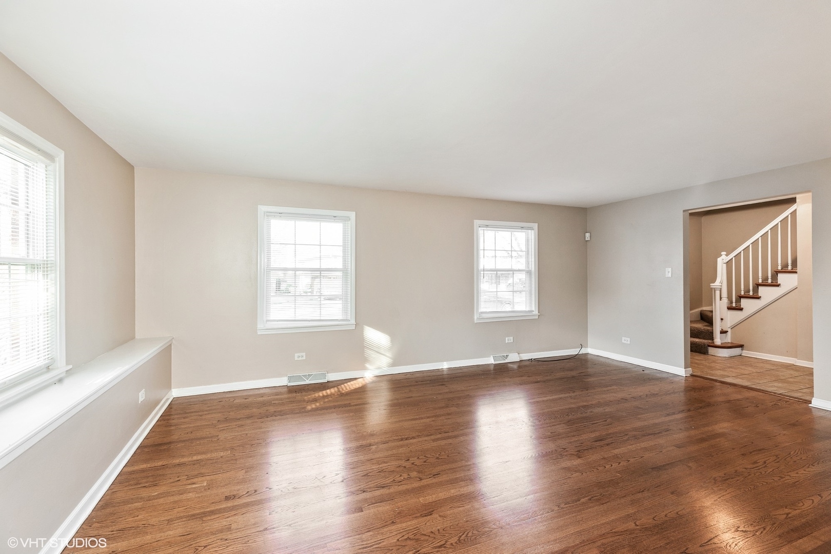 939 Maple Road Flossmoor, IL 60422 - Photo 2 of 23 an empty room with wooden floor and windows