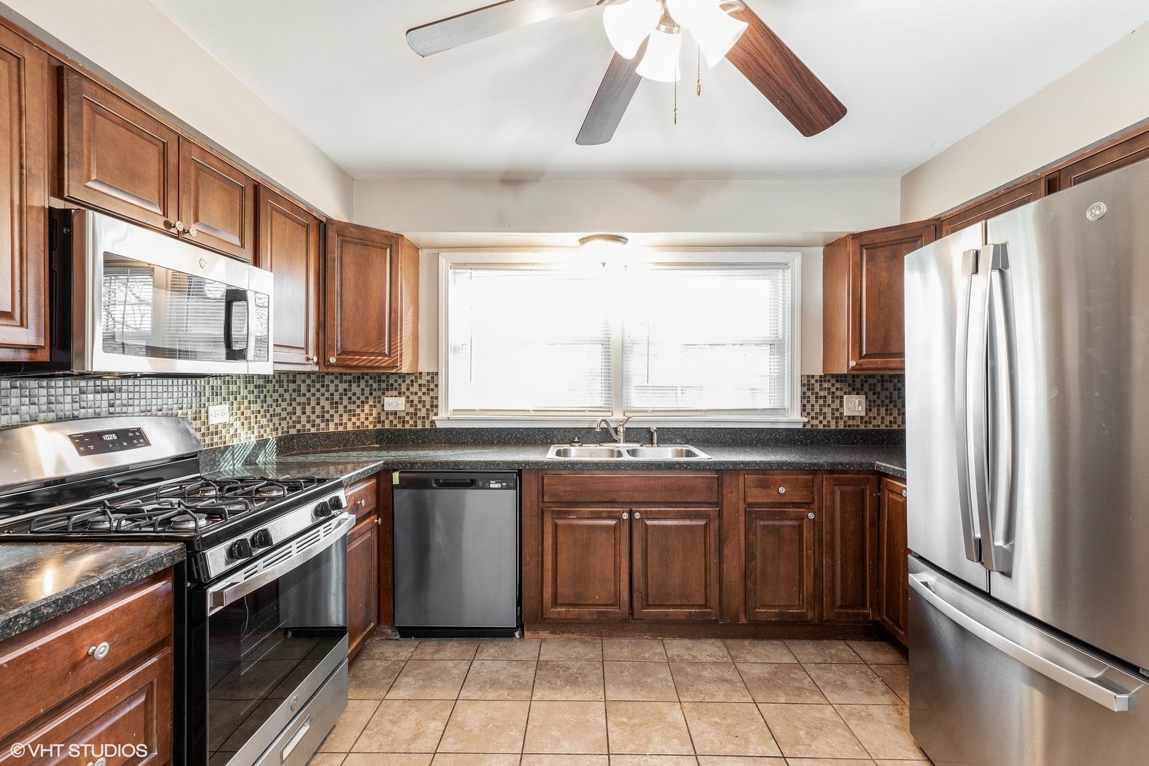 939 Maple Road Flossmoor, IL 60422 - Photo 5 of 23 a kitchen with stainless steel appliances a sink stove and refrigerator