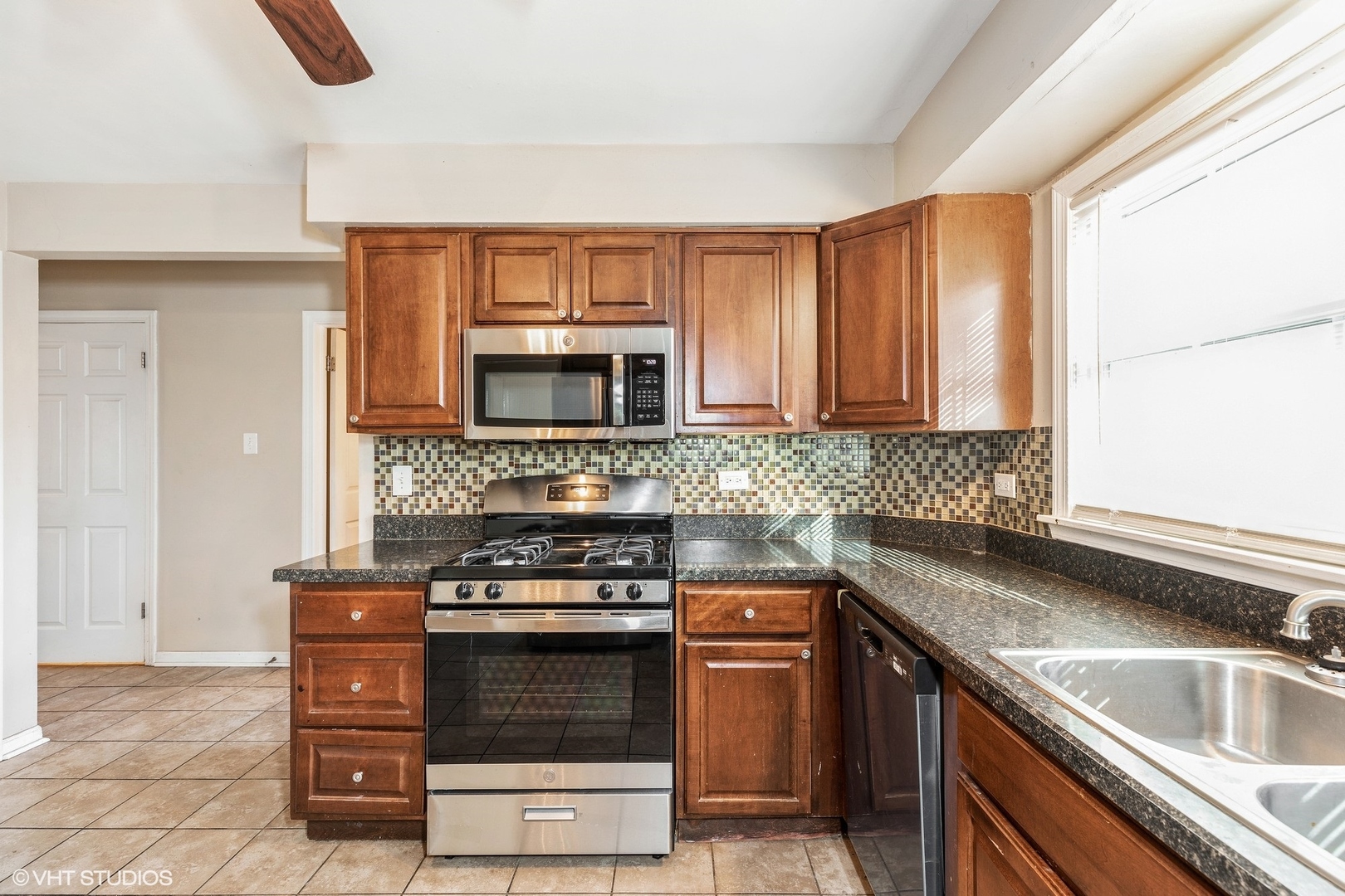 939 Maple Road Flossmoor, IL 60422 - Photo 6 of 23 a kitchen with a sink and a stove top oven