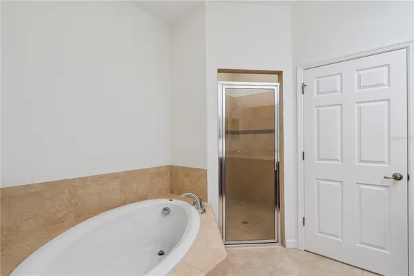 a bathroom with a tub and shower