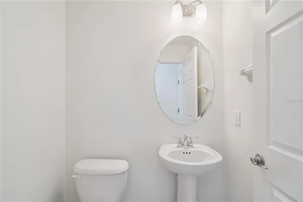 a bathroom with a sink a mirror and a toilet