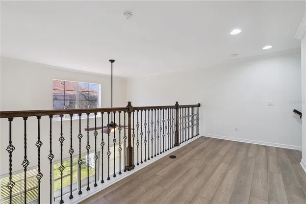 a view of hallway with wooden floor
