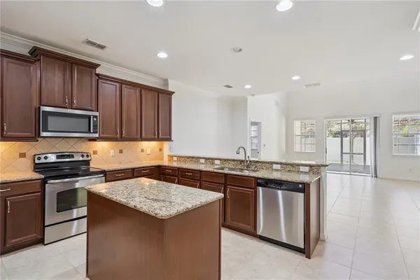 a kitchen with stainless steel appliances granite countertop a stove and a sink
