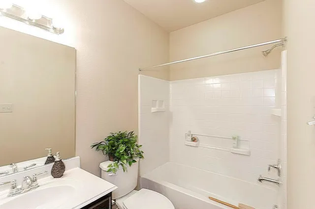 a bathroom with a sink mirror and a shower