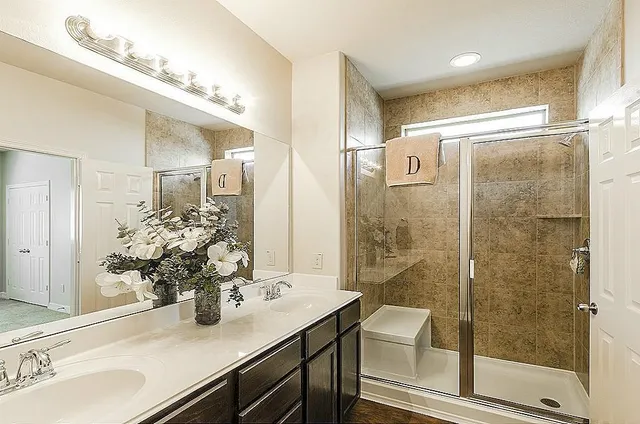 a bathroom with a shower sink and mirror