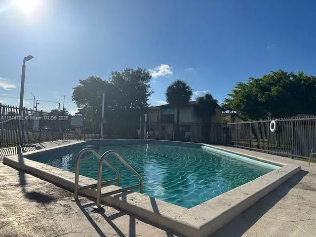a view of a swimming pool with a couple of chairs