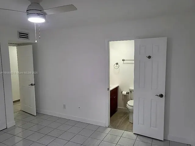 a view of a bathroom with a shower and a toilet